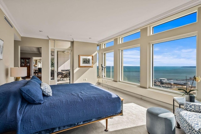 bedroom featuring ornamental molding, a water view, and carpet flooring