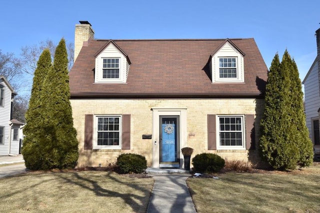 cape cod house with a front yard