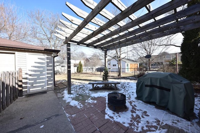 snow covered patio featuring a fire pit, a grill, and a pergola