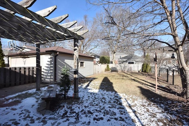 snowy yard with a pergola