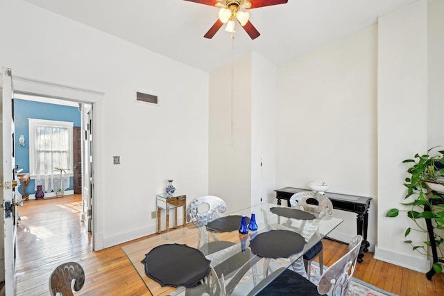 dining room with ceiling fan and light wood-type flooring