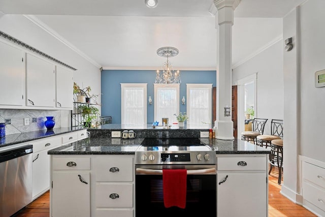 kitchen with white cabinetry, tasteful backsplash, a center island, and appliances with stainless steel finishes