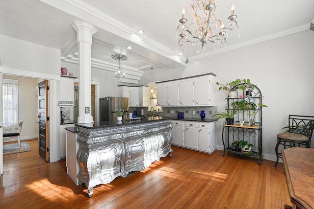 kitchen featuring sink, dark wood-type flooring, stainless steel fridge, tasteful backsplash, and white cabinets