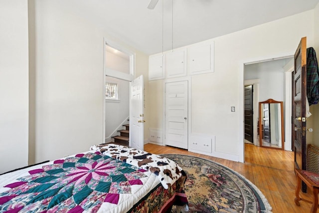 bedroom featuring ceiling fan, light hardwood / wood-style floors, and a closet