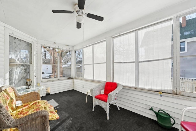 sunroom featuring ceiling fan and plenty of natural light