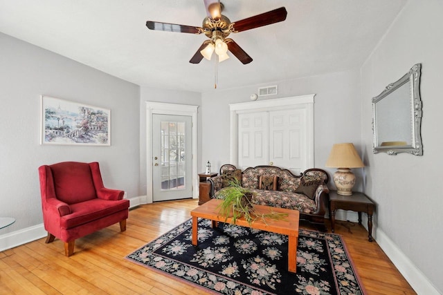 living room with hardwood / wood-style flooring and ceiling fan