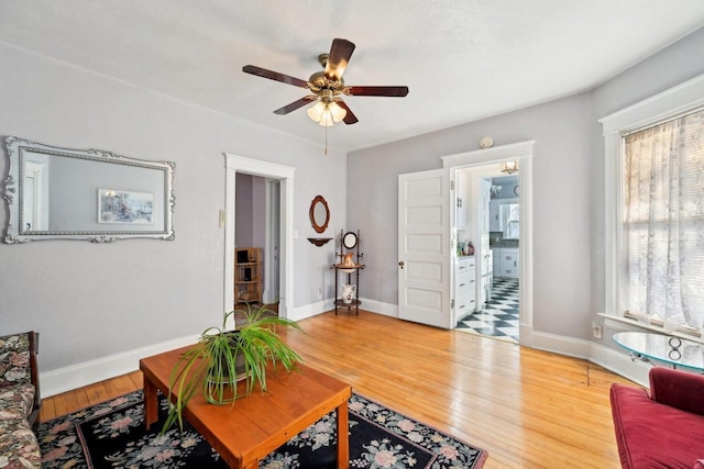 living room with hardwood / wood-style floors and ceiling fan