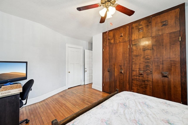 bedroom featuring hardwood / wood-style flooring, vaulted ceiling, and ceiling fan