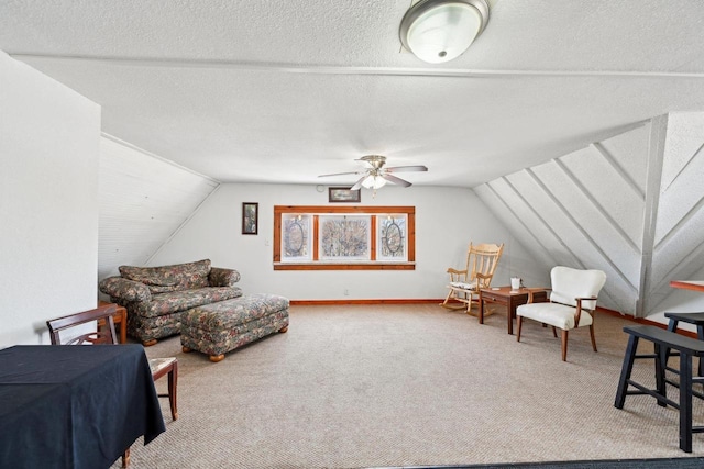 sitting room featuring vaulted ceiling, carpet, and a textured ceiling