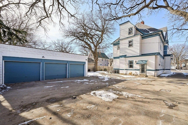 view of side of property with a garage and an outdoor structure