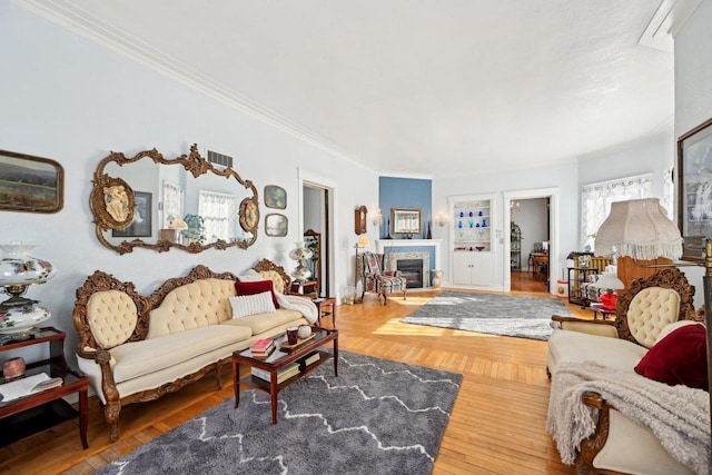 living room featuring crown molding and hardwood / wood-style flooring