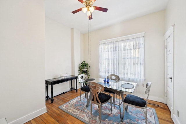 dining room with ceiling fan and light hardwood / wood-style floors