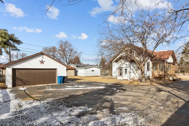 view of front of house with a garage and an outdoor structure