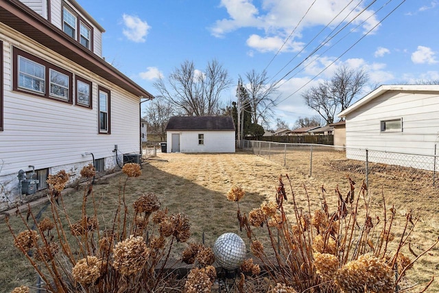 view of yard with cooling unit and a storage shed