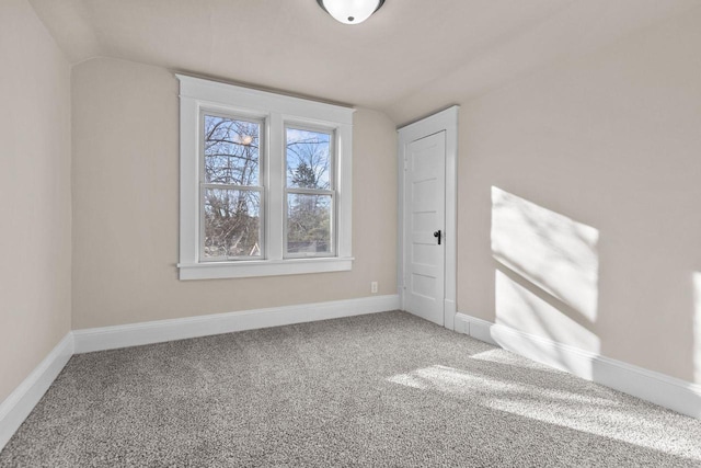 interior space with vaulted ceiling and carpet