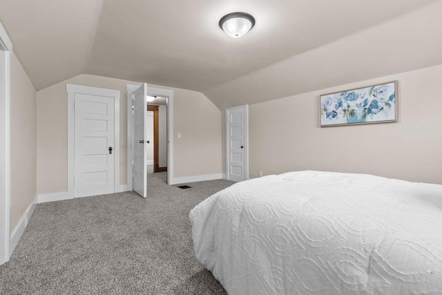 bedroom featuring lofted ceiling and carpet flooring