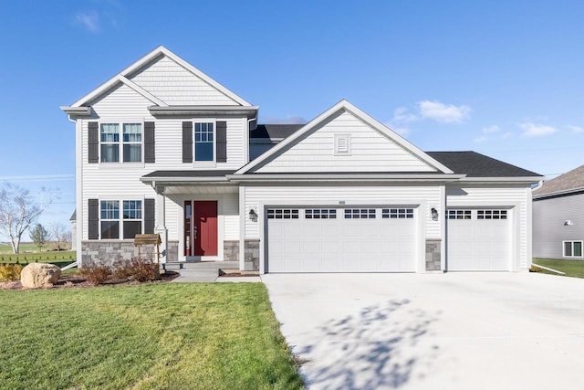 craftsman inspired home with a garage and a front lawn