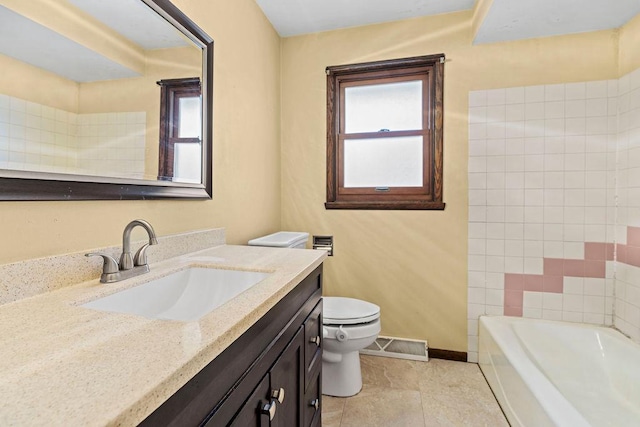 bathroom featuring vanity, tile patterned floors, and toilet