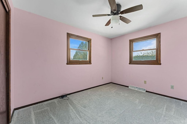 carpeted empty room with ceiling fan