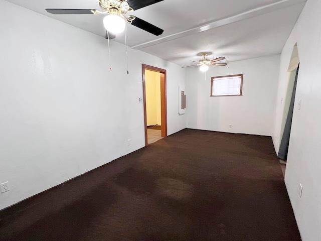 carpeted spare room with ceiling fan