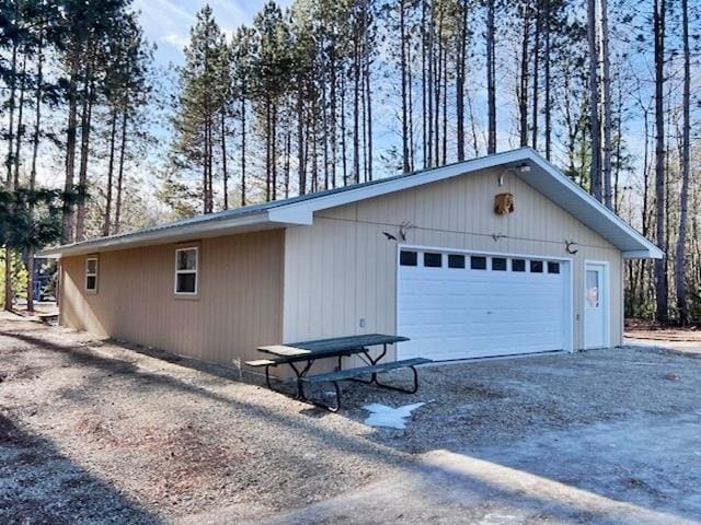 view of home's exterior featuring a detached garage and an outdoor structure