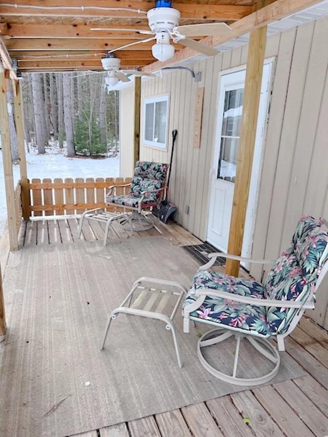 wooden deck featuring a ceiling fan