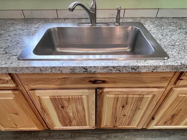 details featuring light countertops and a sink