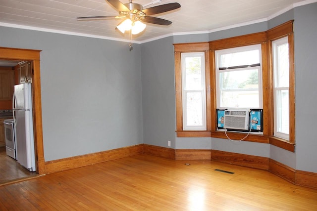 unfurnished room with cooling unit, hardwood / wood-style floors, crown molding, and ceiling fan