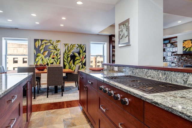 kitchen featuring stainless steel gas cooktop and light stone counters