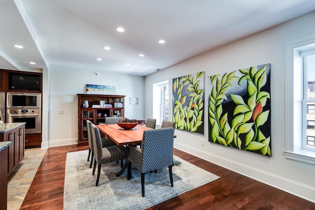 dining space with hardwood / wood-style floors