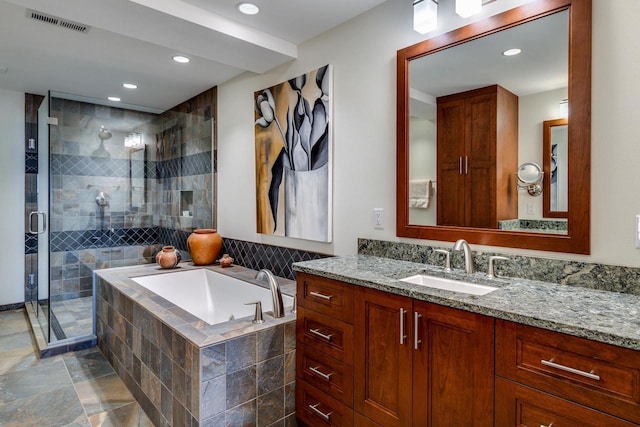 bathroom featuring vanity and separate shower and tub