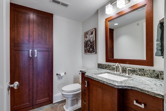 bathroom with vanity and toilet