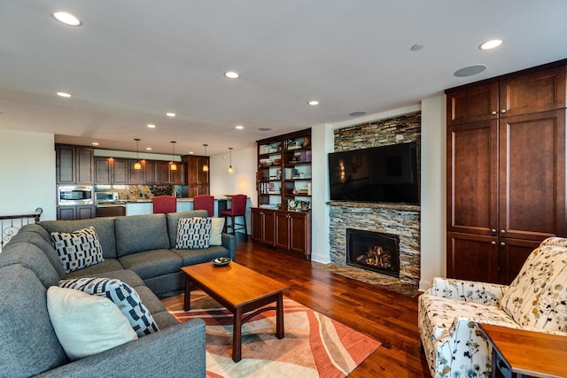 living room with a fireplace and dark hardwood / wood-style flooring