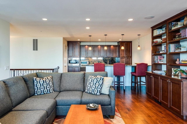 living room featuring dark wood-type flooring