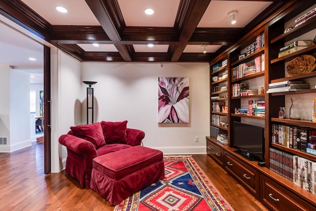 living area featuring coffered ceiling, crown molding, dark hardwood / wood-style floors, and beamed ceiling