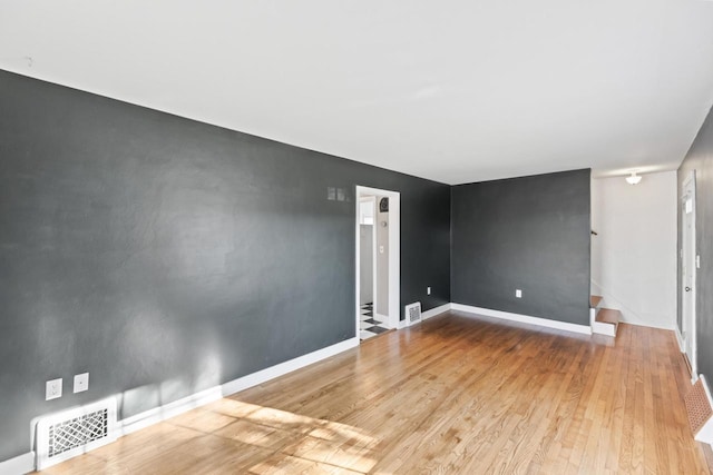 empty room with light hardwood / wood-style flooring