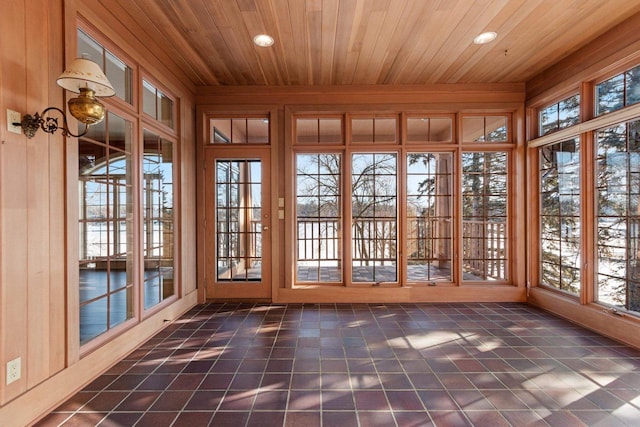 unfurnished sunroom featuring plenty of natural light and wooden ceiling