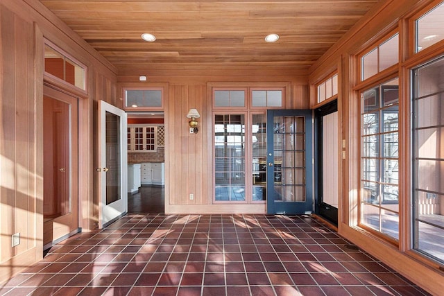 unfurnished sunroom featuring wooden ceiling