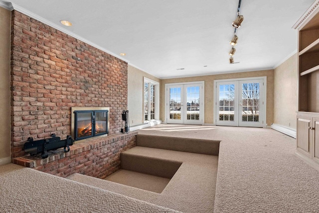 living room with carpet flooring, a fireplace, ornamental molding, and baseboard heating