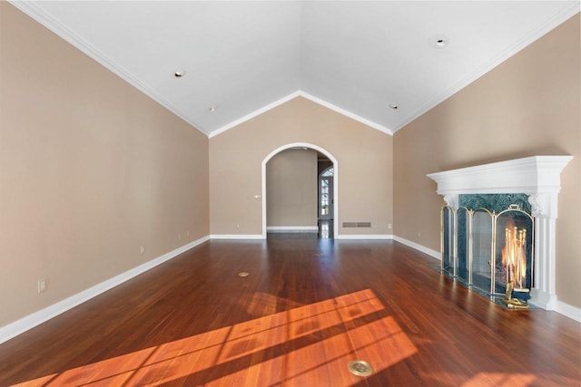 unfurnished living room featuring lofted ceiling, a premium fireplace, crown molding, and dark hardwood / wood-style floors