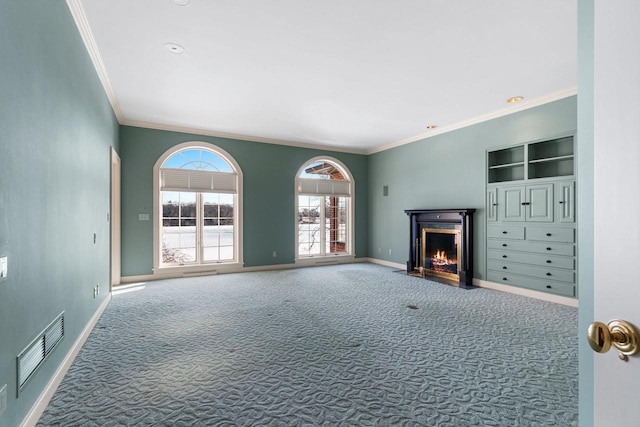 unfurnished living room with crown molding and carpet floors