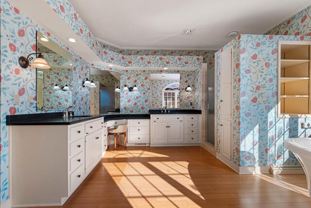 bathroom featuring hardwood / wood-style flooring, vanity, and crown molding