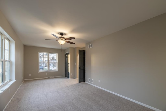 empty room with light carpet and ceiling fan