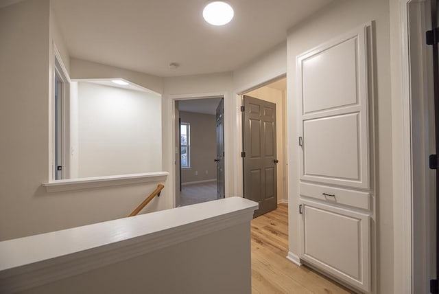 hallway with light hardwood / wood-style floors