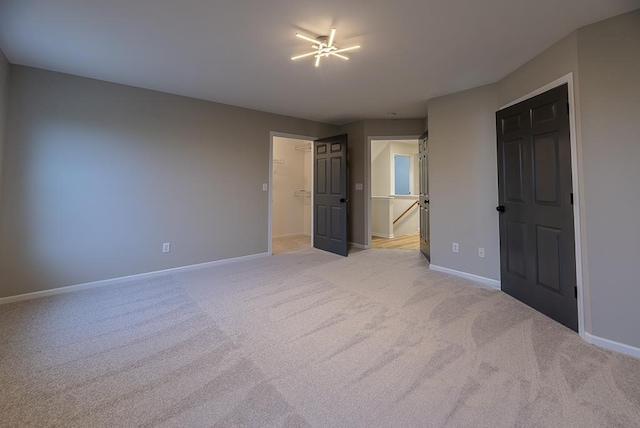 unfurnished bedroom featuring light carpet and a closet