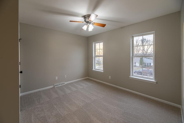 unfurnished room featuring light carpet and ceiling fan