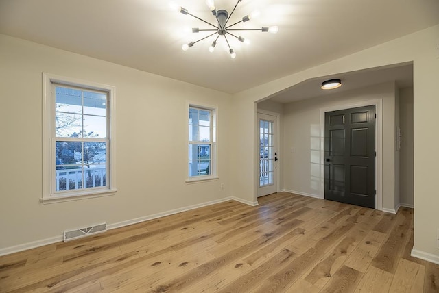 entryway with a chandelier and light hardwood / wood-style flooring