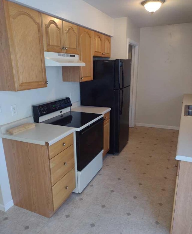 kitchen featuring black fridge, electric range, and light brown cabinetry