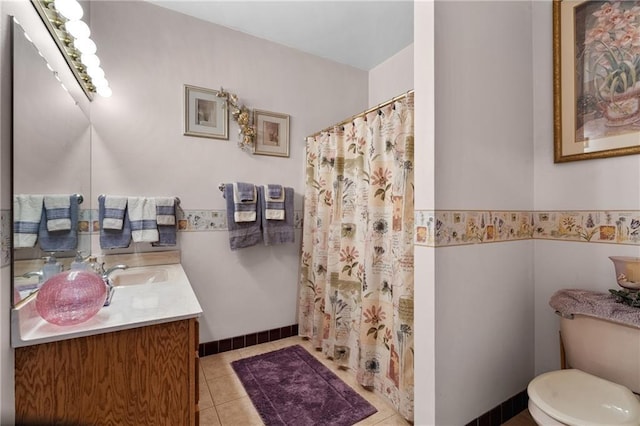 bathroom featuring vanity, a shower with shower curtain, tile patterned floors, and toilet