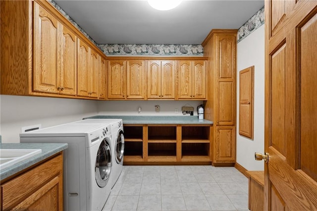 washroom with cabinets and washer and dryer